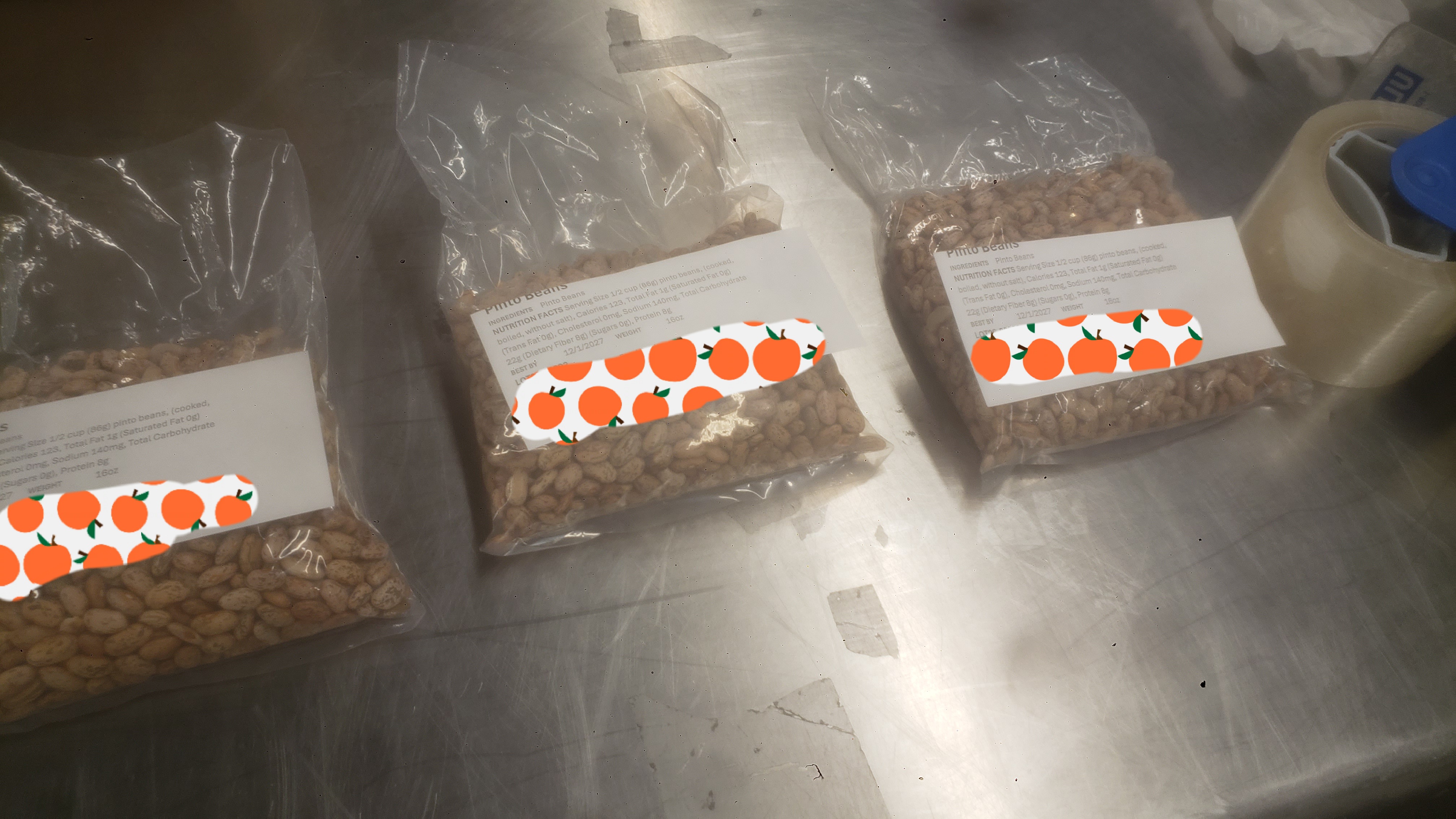 Three bags of pinto beans with label.